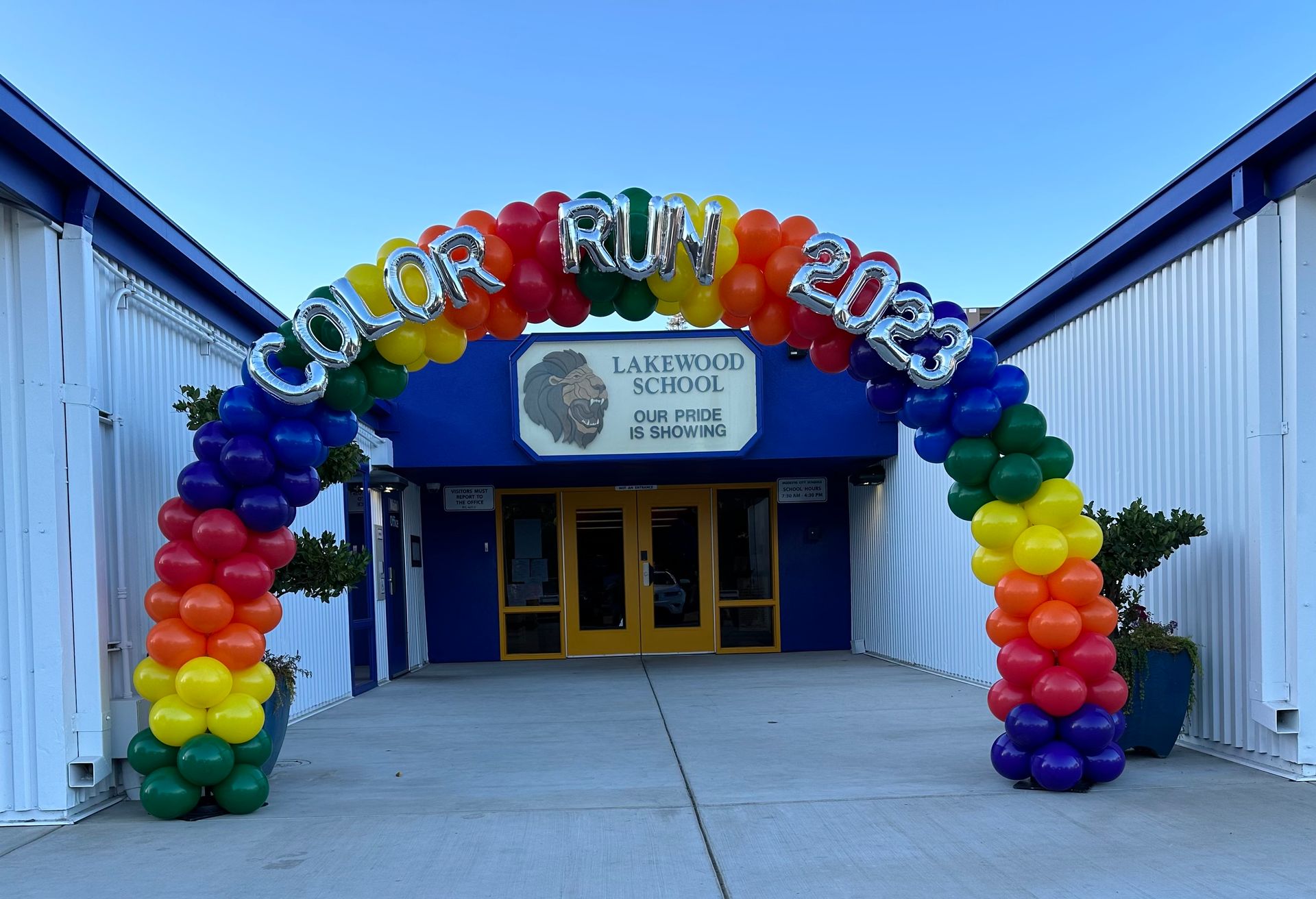 Rainbow balloon arch entrance for Lakewood School Color Run 2023.