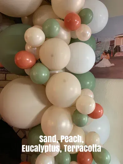 Balloon garland with sand, peach, eucalyptus, and terracotta colors.
