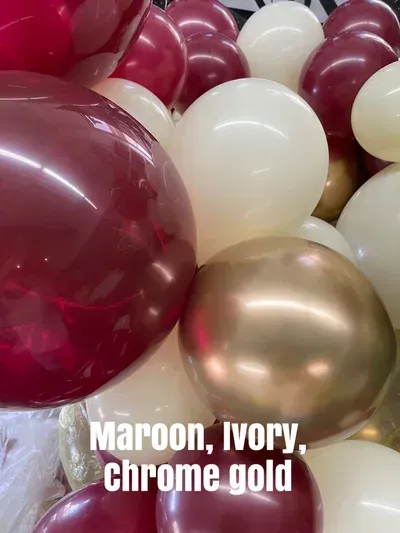 Maroon, ivory, and gold balloons form a celebratory cluster.