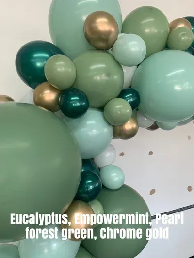Balloon garland with eucalyptus, empowerment, forest green, chrome gold, and pearl colors.