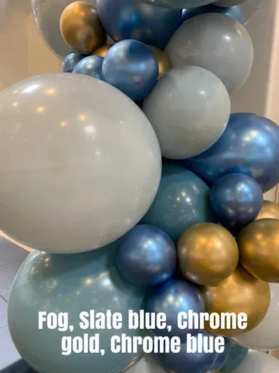 Balloon garland: Fog, slate blue, chrome gold, chrome blue balloons create a textured, celebratory display.