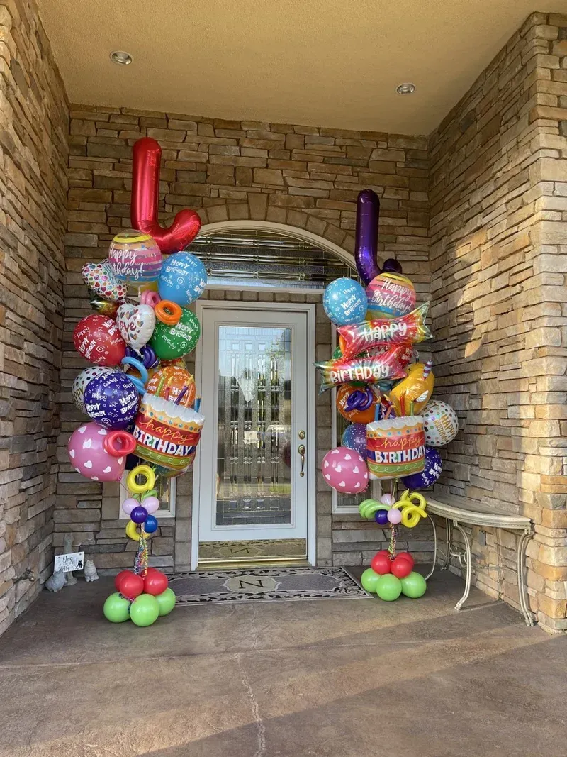 Two balloon columns flank a front door.  One has a red 