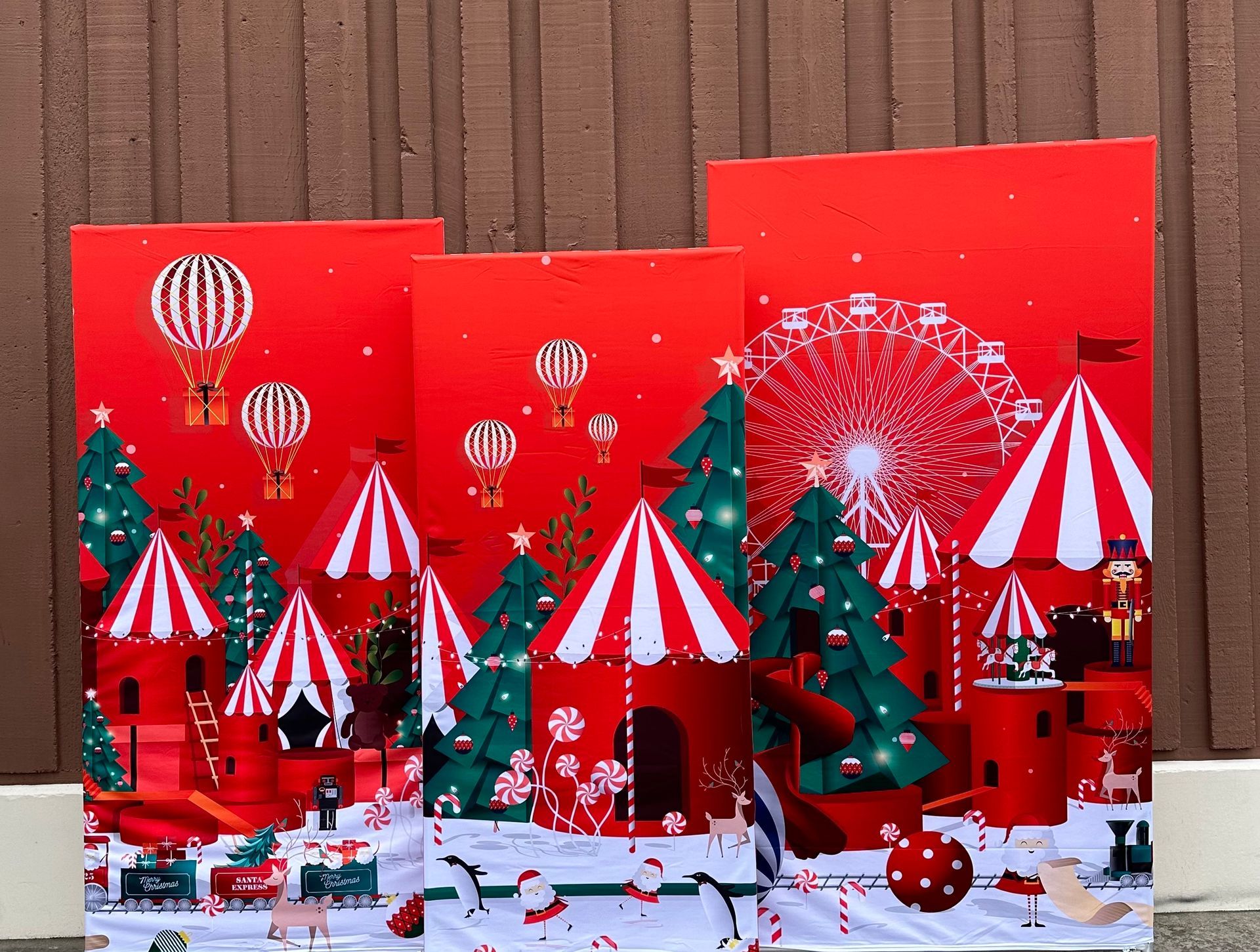 Red Christmas circus scene with hot air balloons and Ferris wheel.