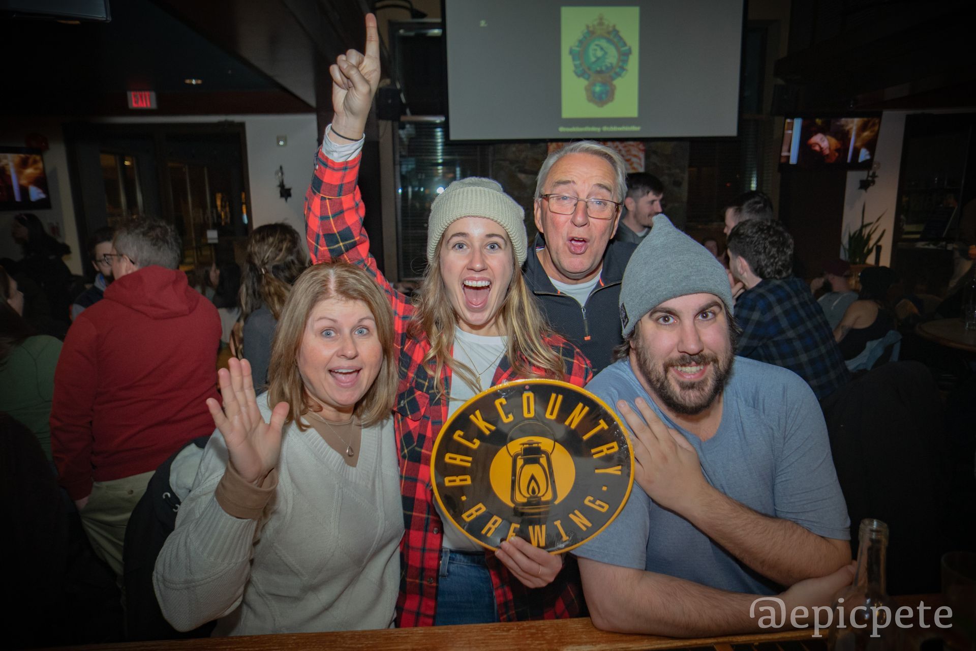 A group of people are posing for a picture in a bar.