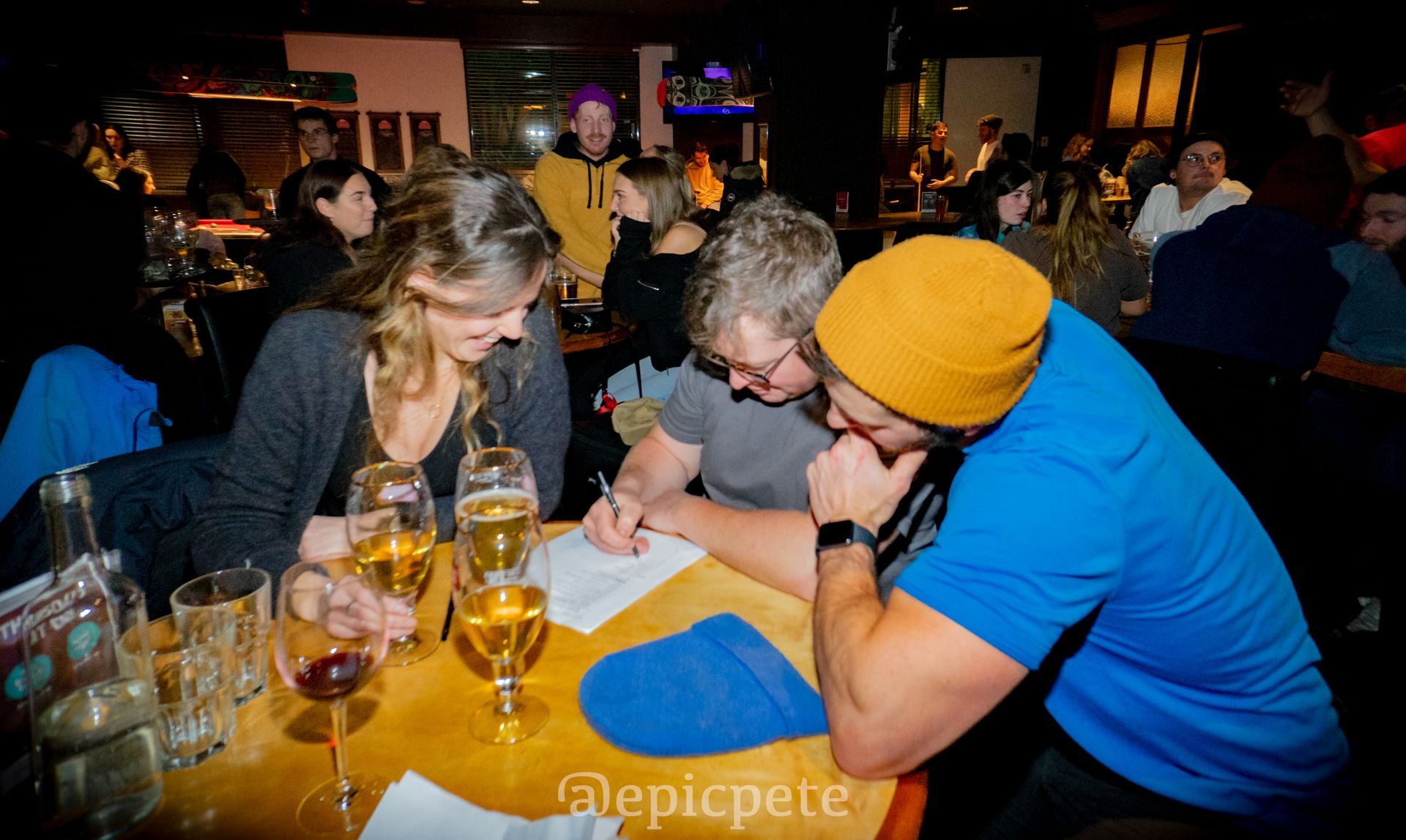 A group of people sitting at a table with epicpete written on the bottom