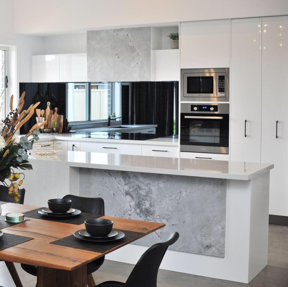 A kitchen with a table and chairs in it