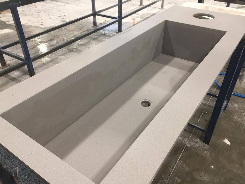 A bathtub with a hole in the middle is sitting on a table.