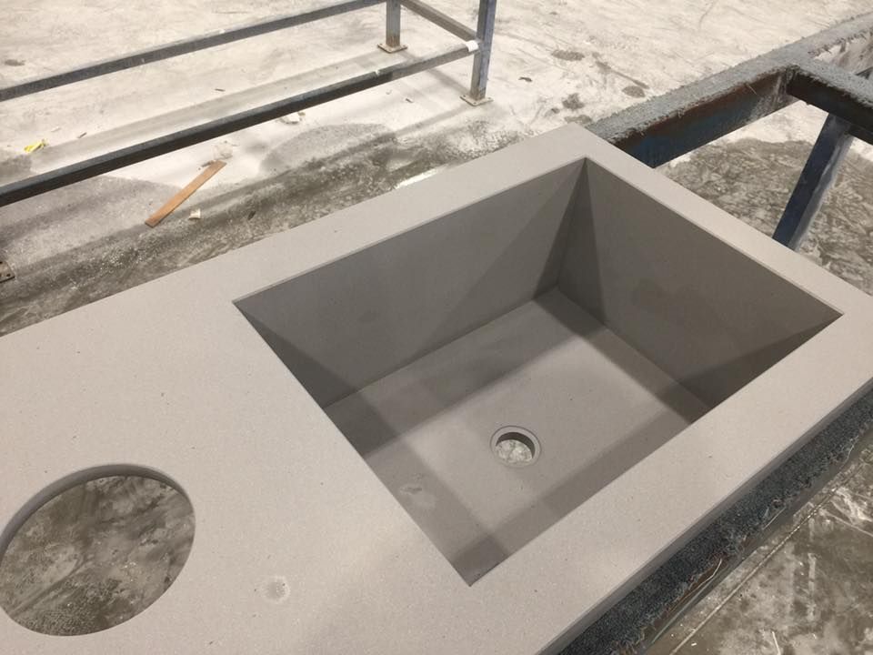 A sink with a hole in the middle is sitting on a table.