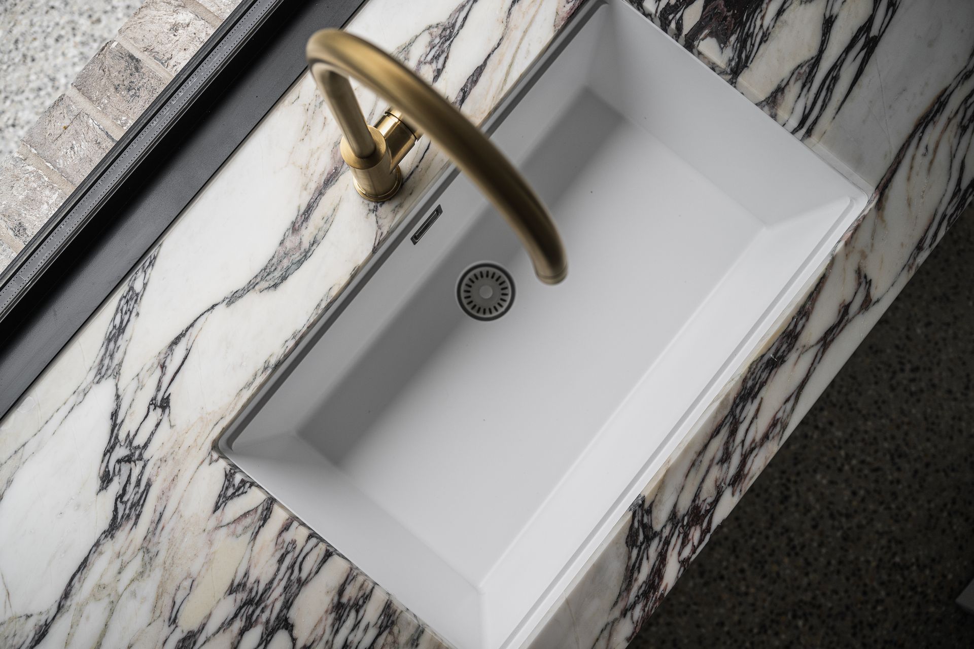 A kitchen with black cabinets and a white countertop
