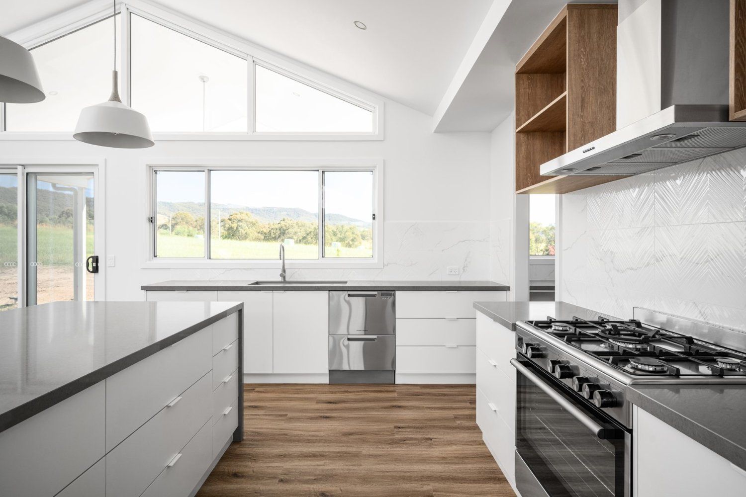 A kitchen with white cabinets and a granite counter top.