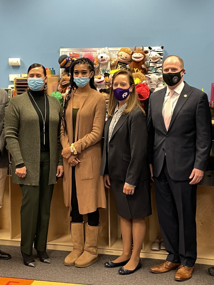 A group of people wearing face masks are posing for a picture.