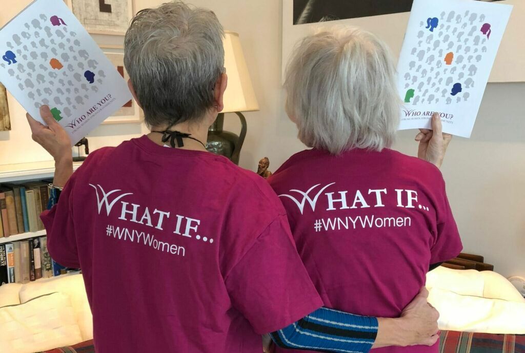Two women wearing purple shirts that say what if