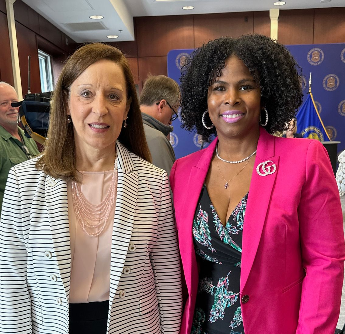 A group of people wearing face masks are posing for a picture.