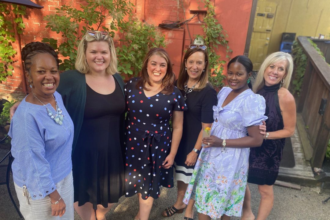 A group of women are posing for a picture together.