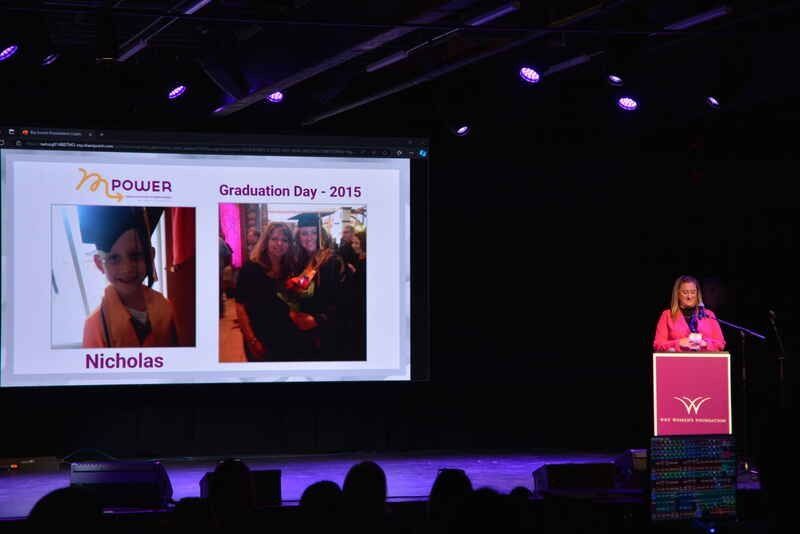 A woman is giving a speech at a graduation ceremony