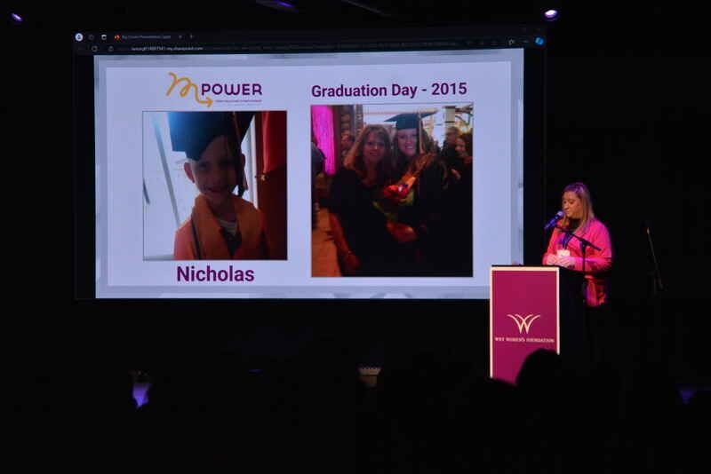 A woman is giving a speech at a graduation ceremony