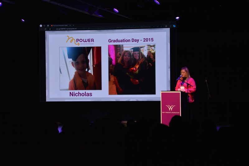A woman is giving a speech at a graduation ceremony