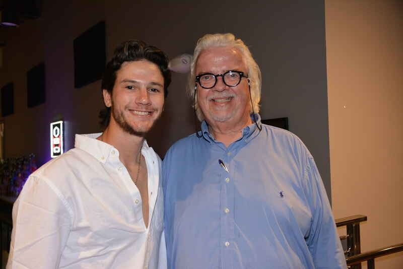 A man and a young man are posing for a picture together.