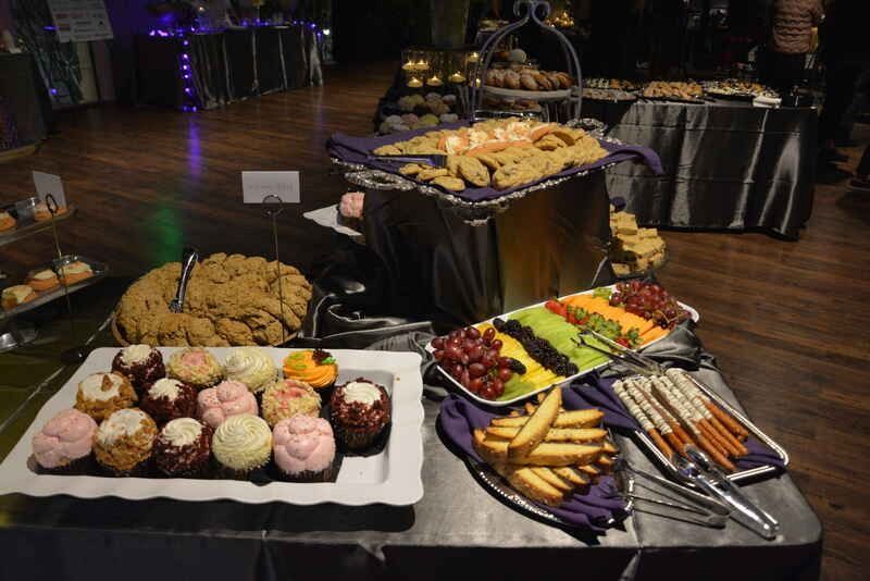 A buffet table with a variety of desserts and snacks on it.