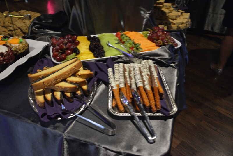 A table with a tray of carrots and tongs on it