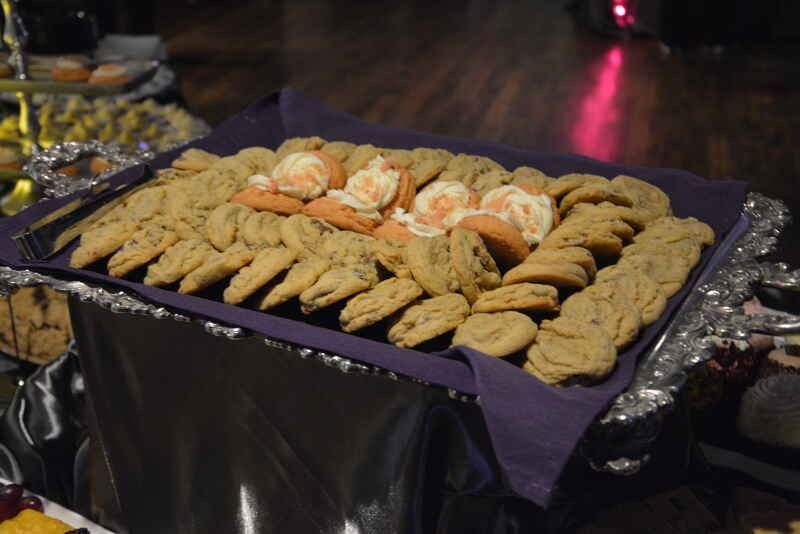 A tray of cookies and carrots on a table.