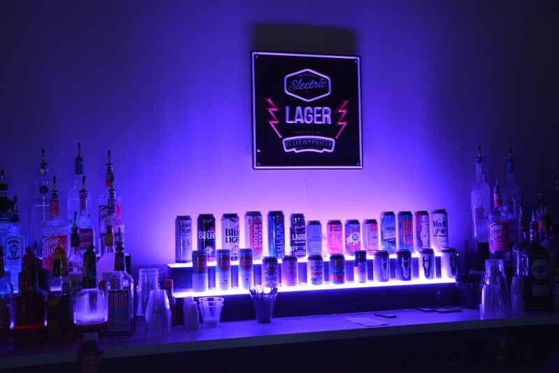 A bar with a neon sign that says lager on it.