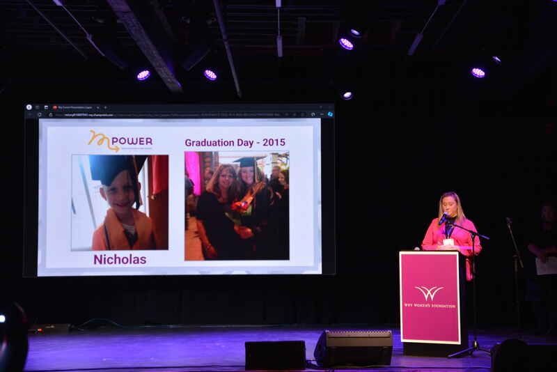 A woman is giving a speech at a graduation ceremony.