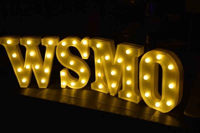 A sign that says wsmo is lit up in the dark