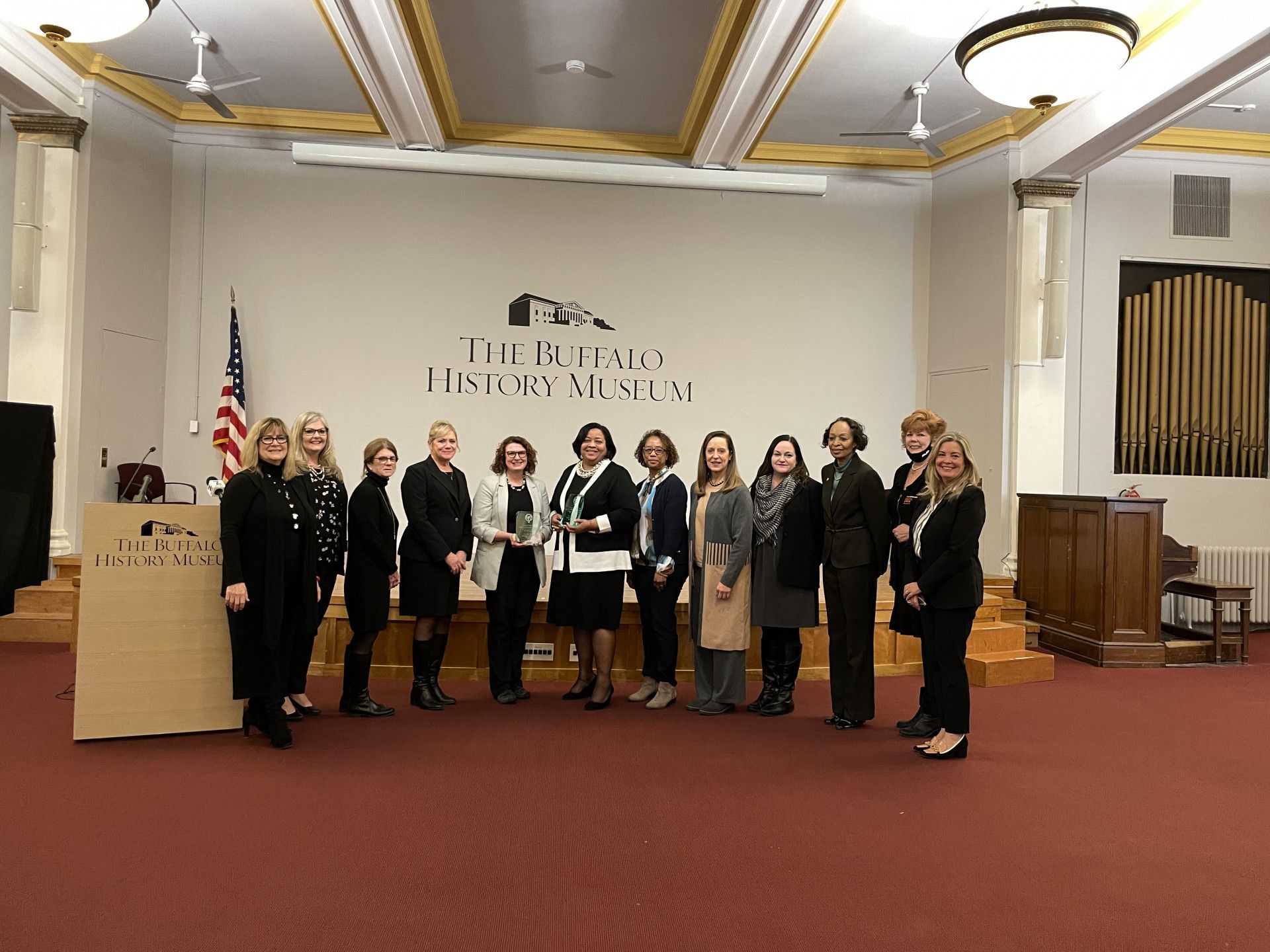 A group of women are posing for a picture in a room.