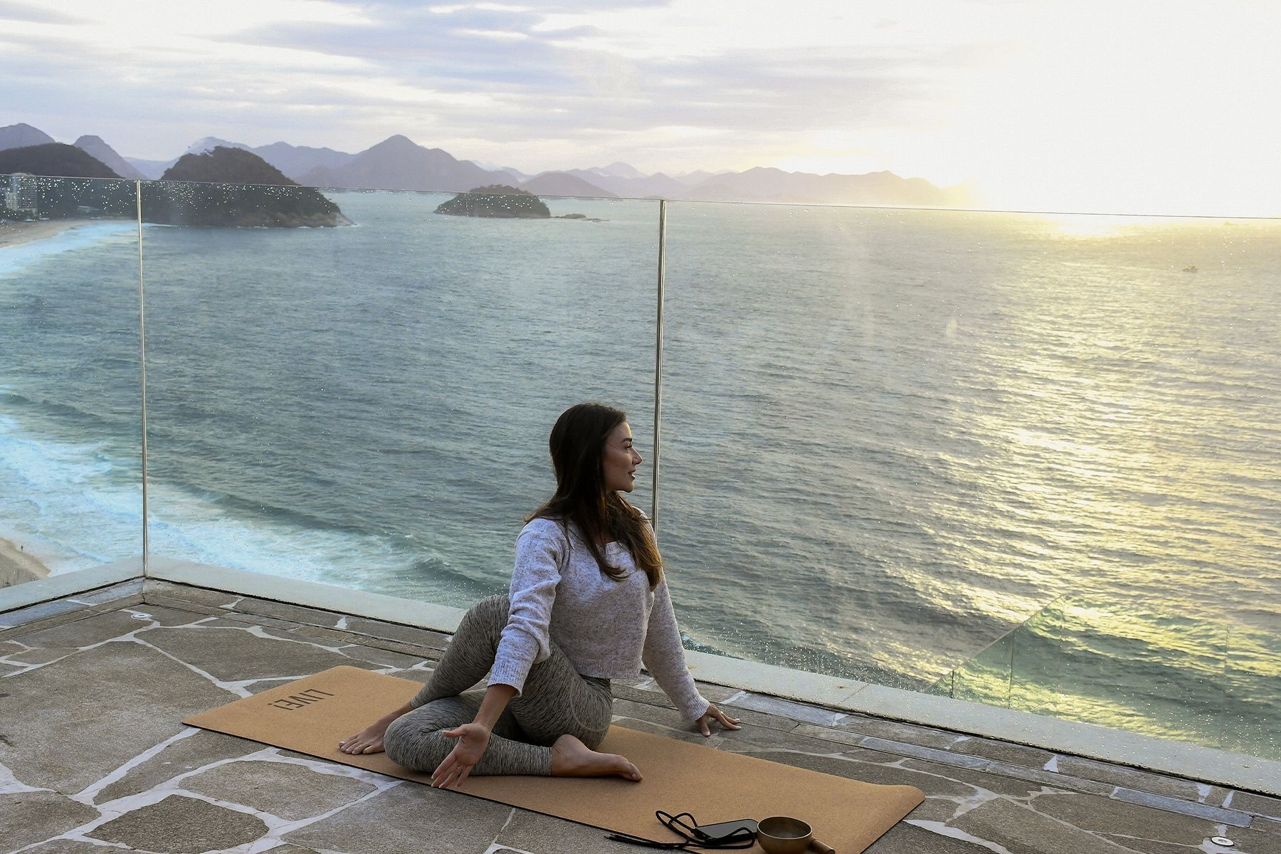 Uma sala grande com fileiras de cadeiras vermelhas e uma tela de projetor.