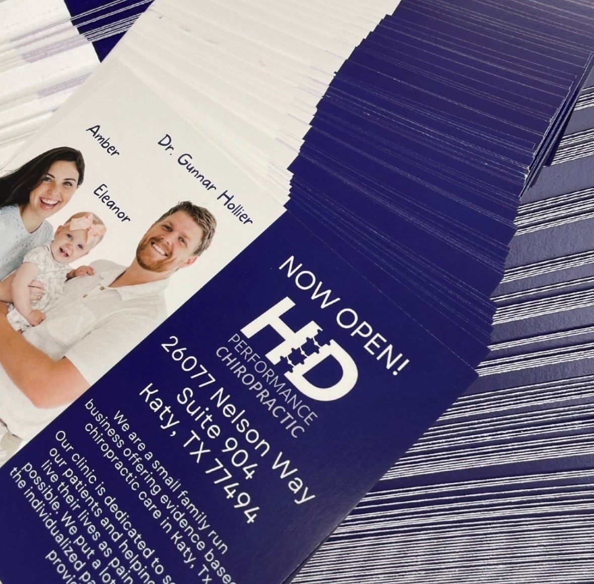 a stack of marketing post cards for a Katy chiropractic clinic