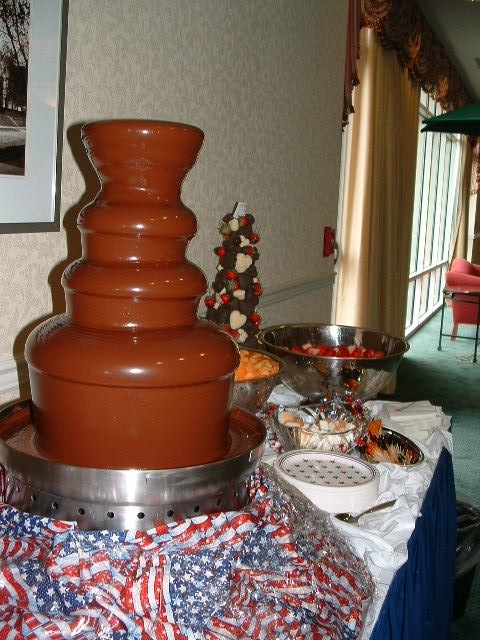 A large chocolate fountain is sitting on a table