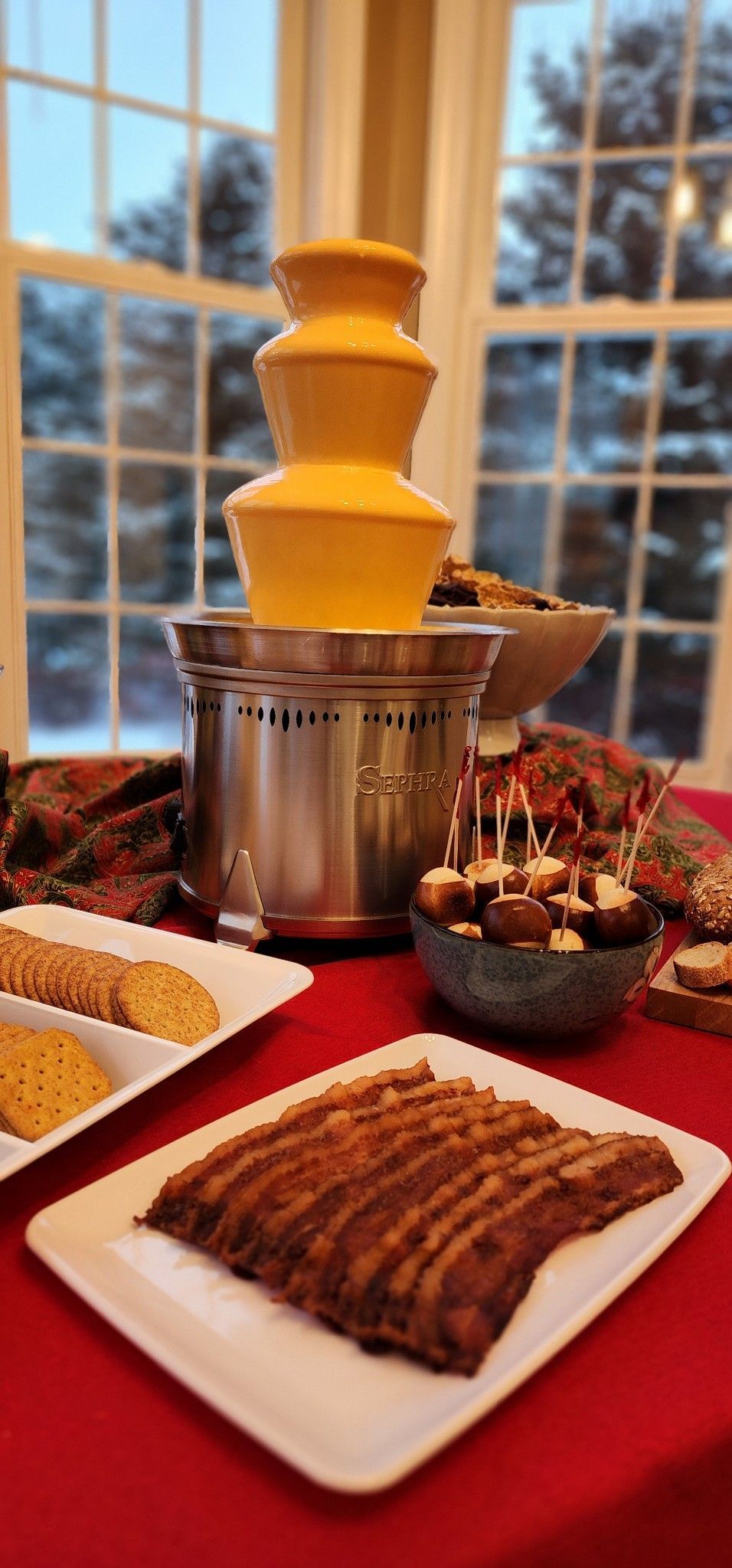 A table topped with plates of food and a chocolate fountain.