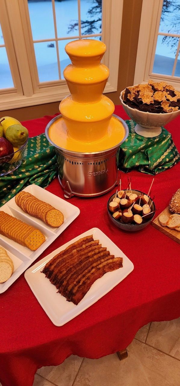 A table topped with plates of food and a chocolate fountain.