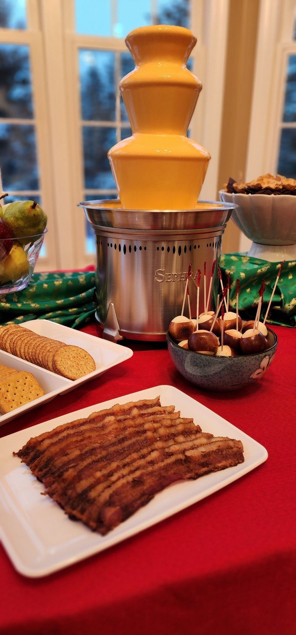 A table topped with plates of food and a chocolate fountain.