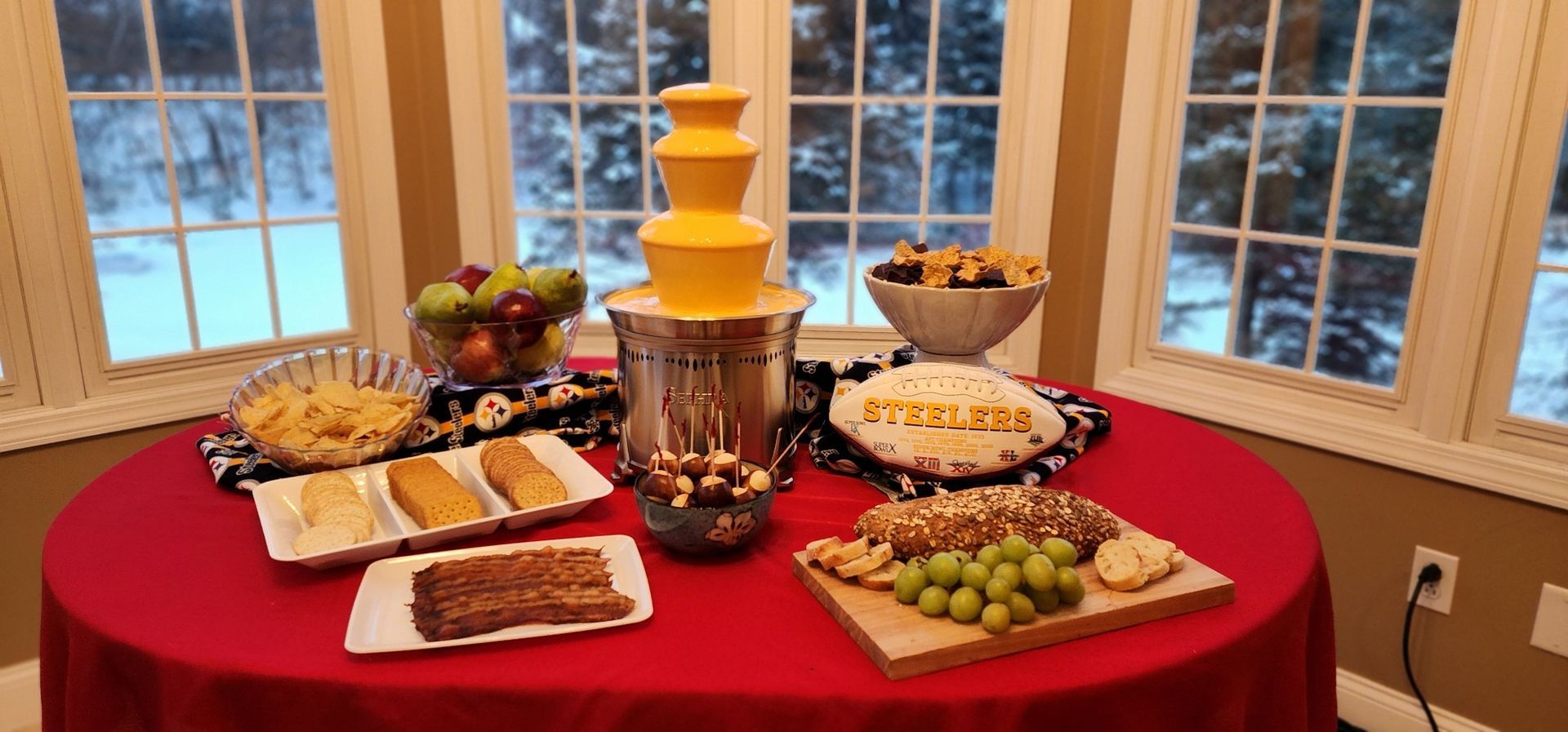 A table topped with plates of food and a chocolate fountain.