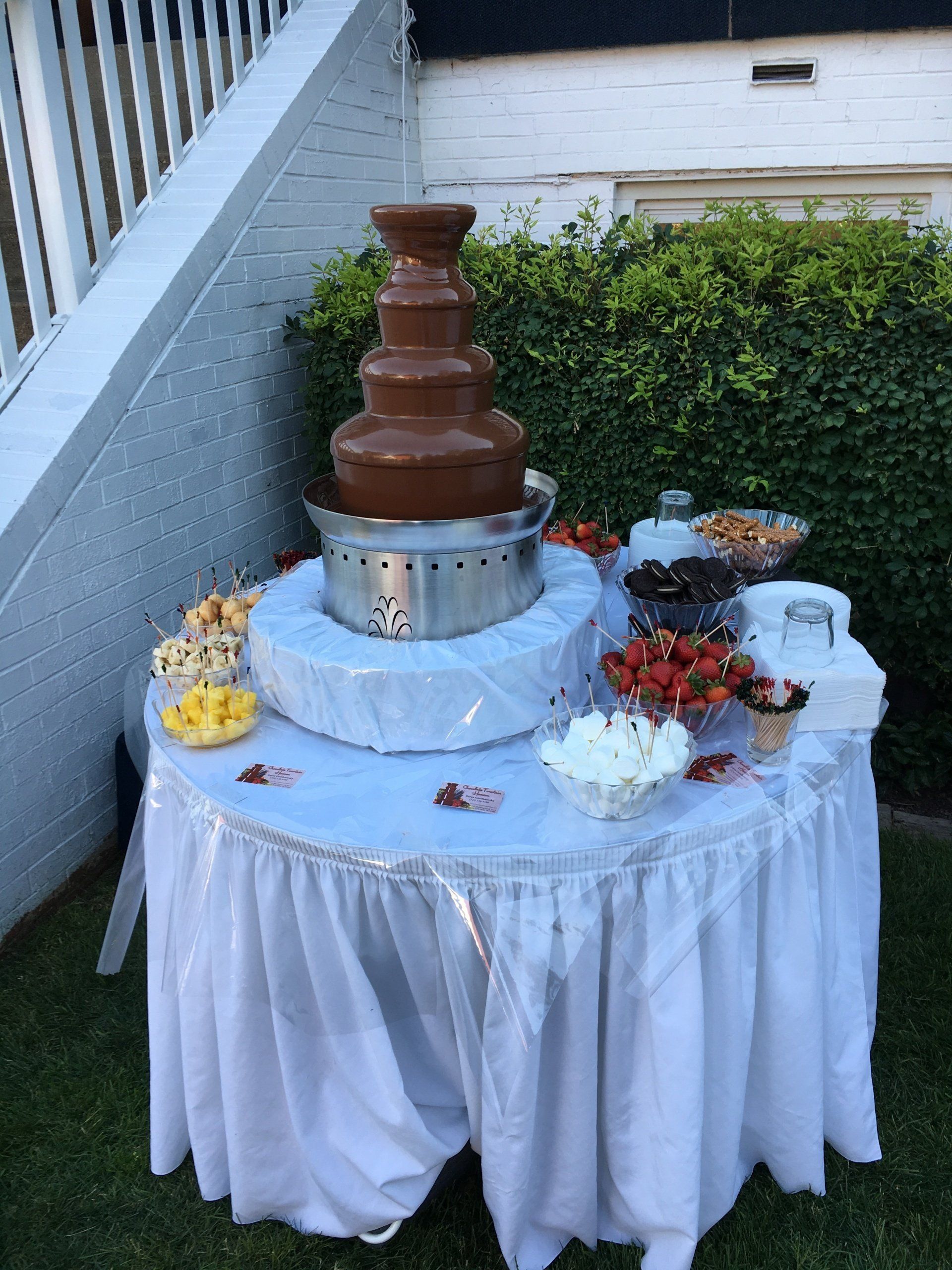A table with a chocolate fountain on top of it.