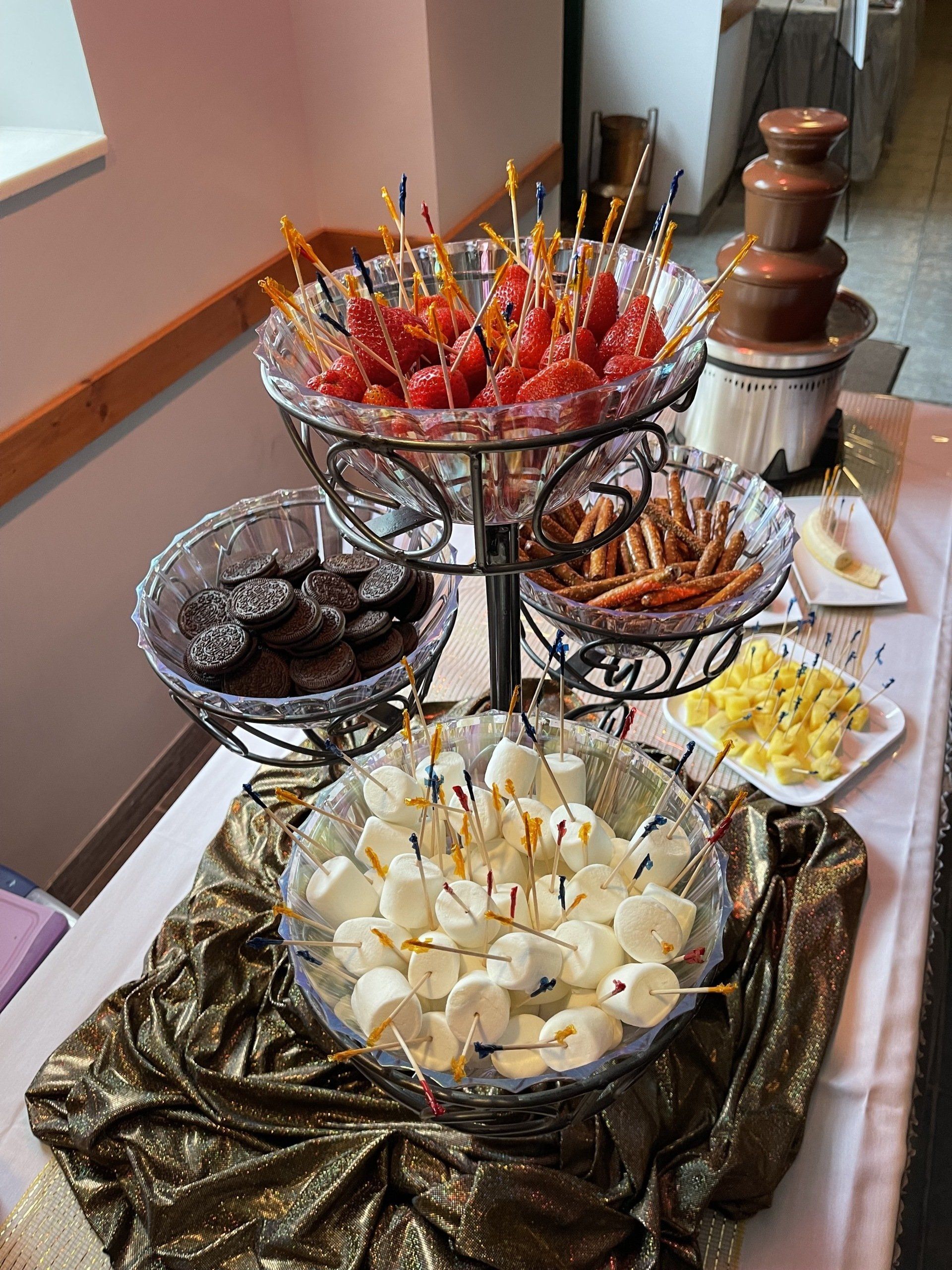 A table topped with bowls of food and a chocolate fountain.