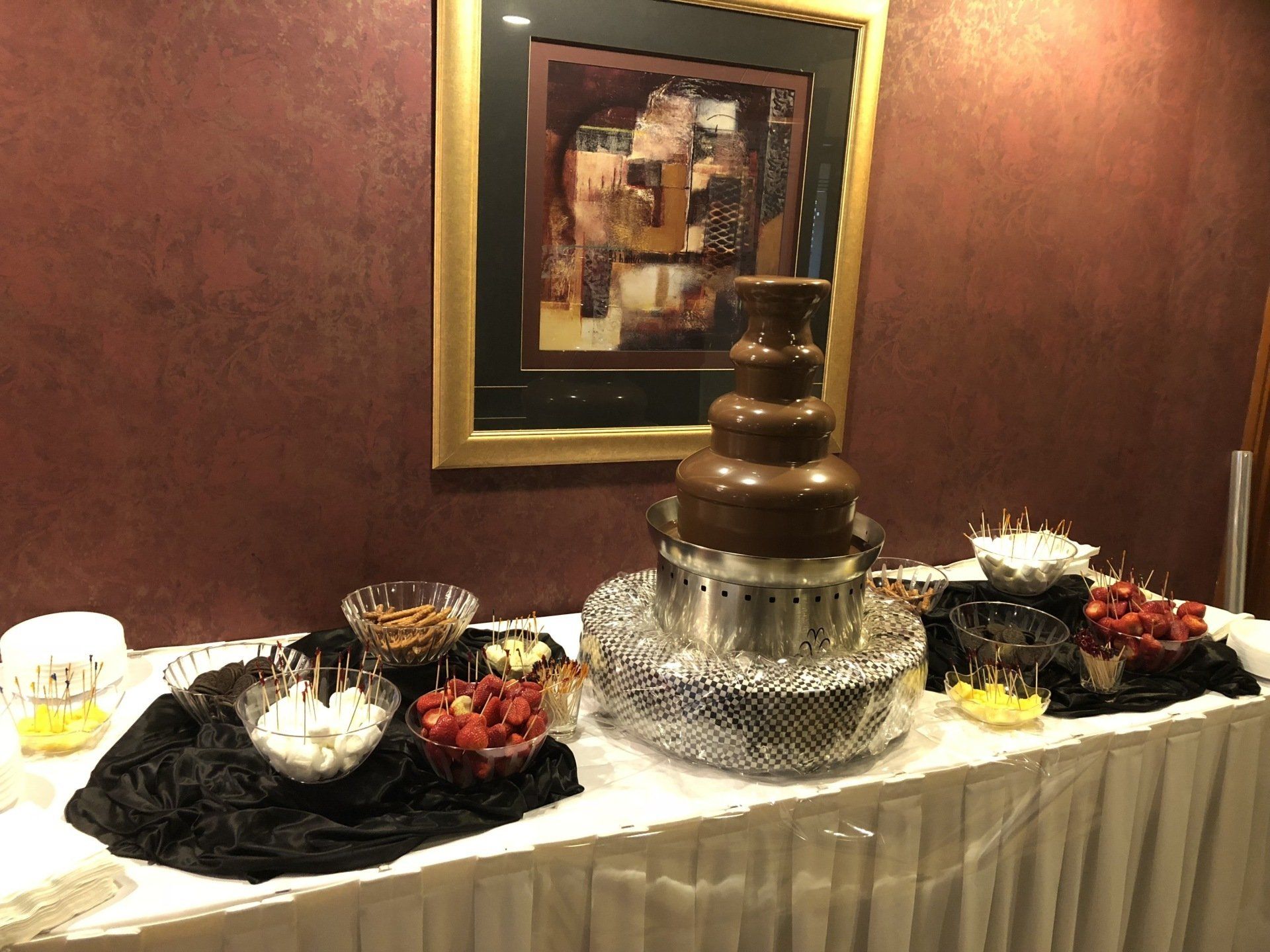 A chocolate fountain is sitting on top of a table.