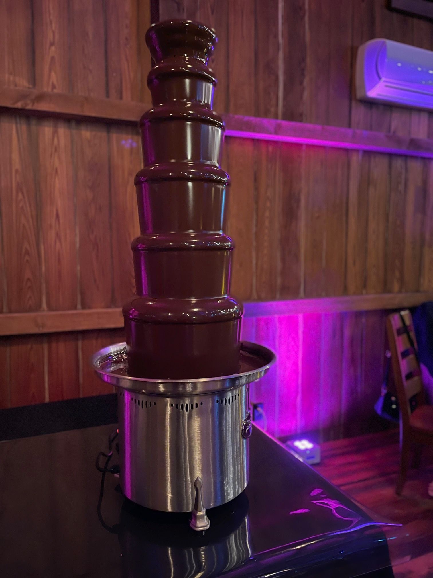 A chocolate fountain is sitting on top of a table.