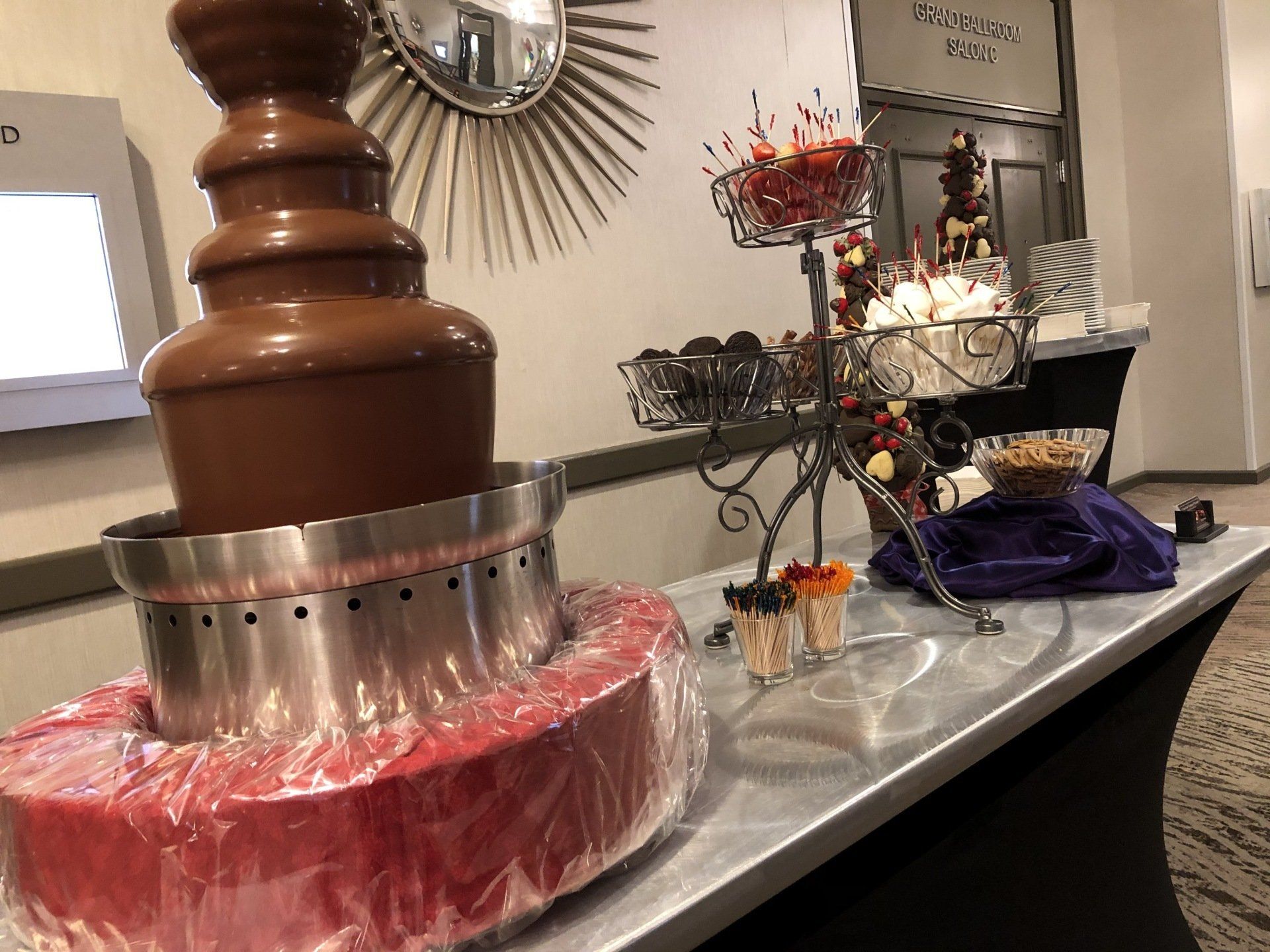A chocolate fountain is sitting on top of a table.