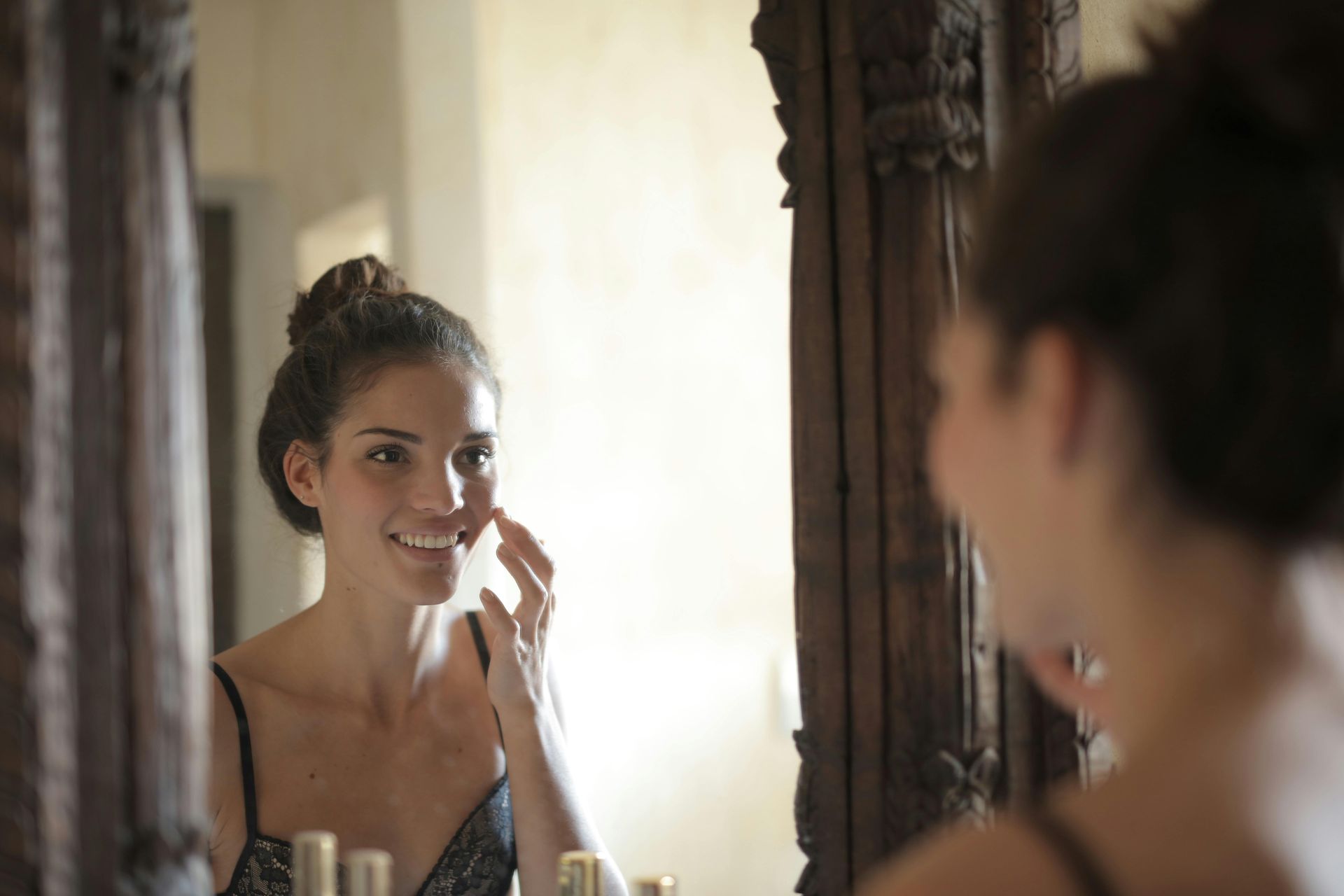 image of a woman smiling in the mirror, click to learn more about schema therapy