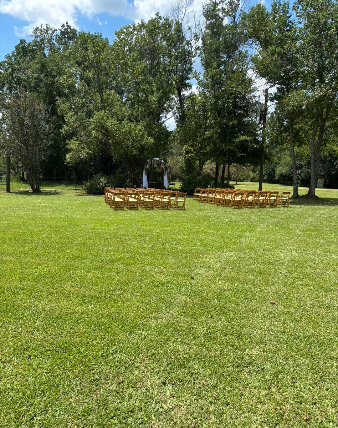 outdoor wedding ceremony under green trees