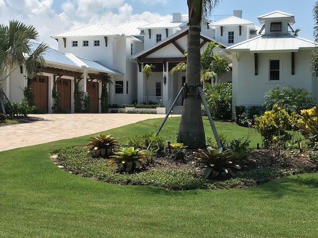 Elegant House With Coconut Tree — Naples FL — Garage Doors of Naples