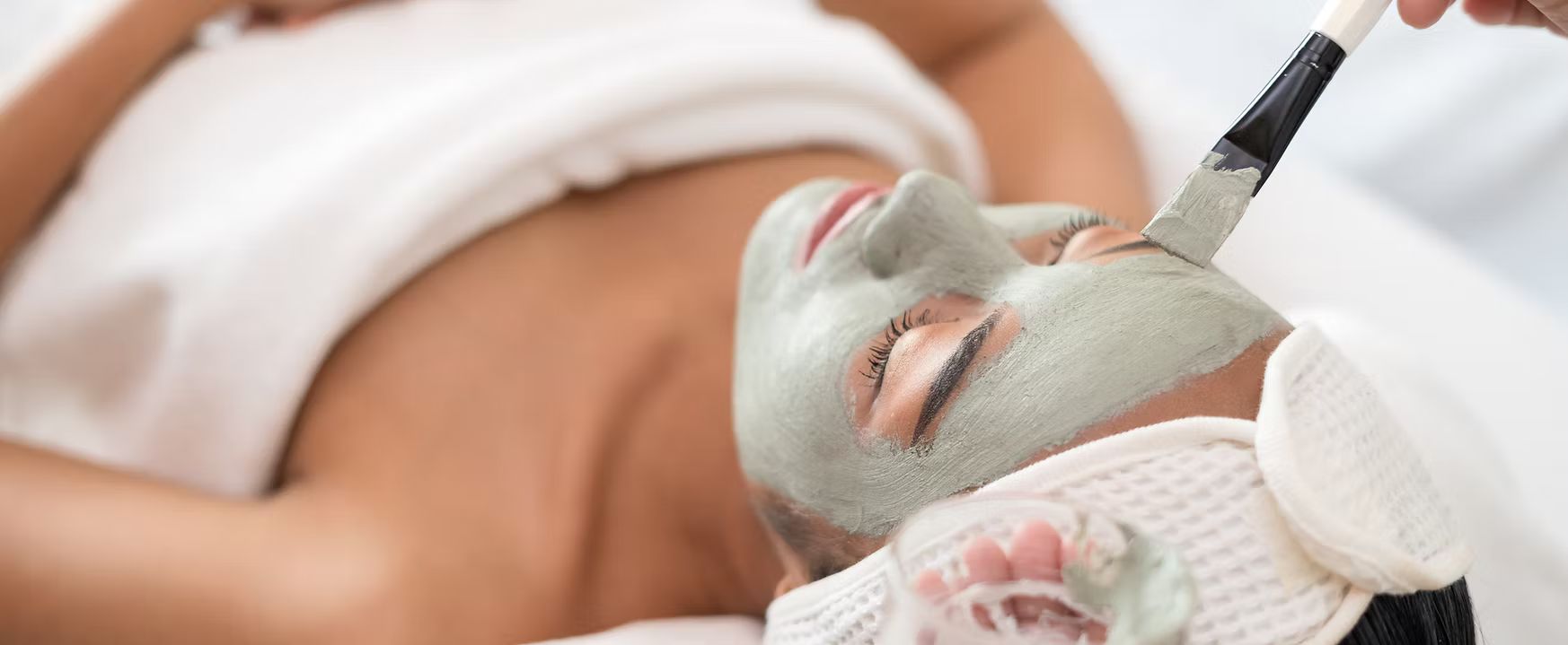 A woman is getting a facial treatment at a spa.