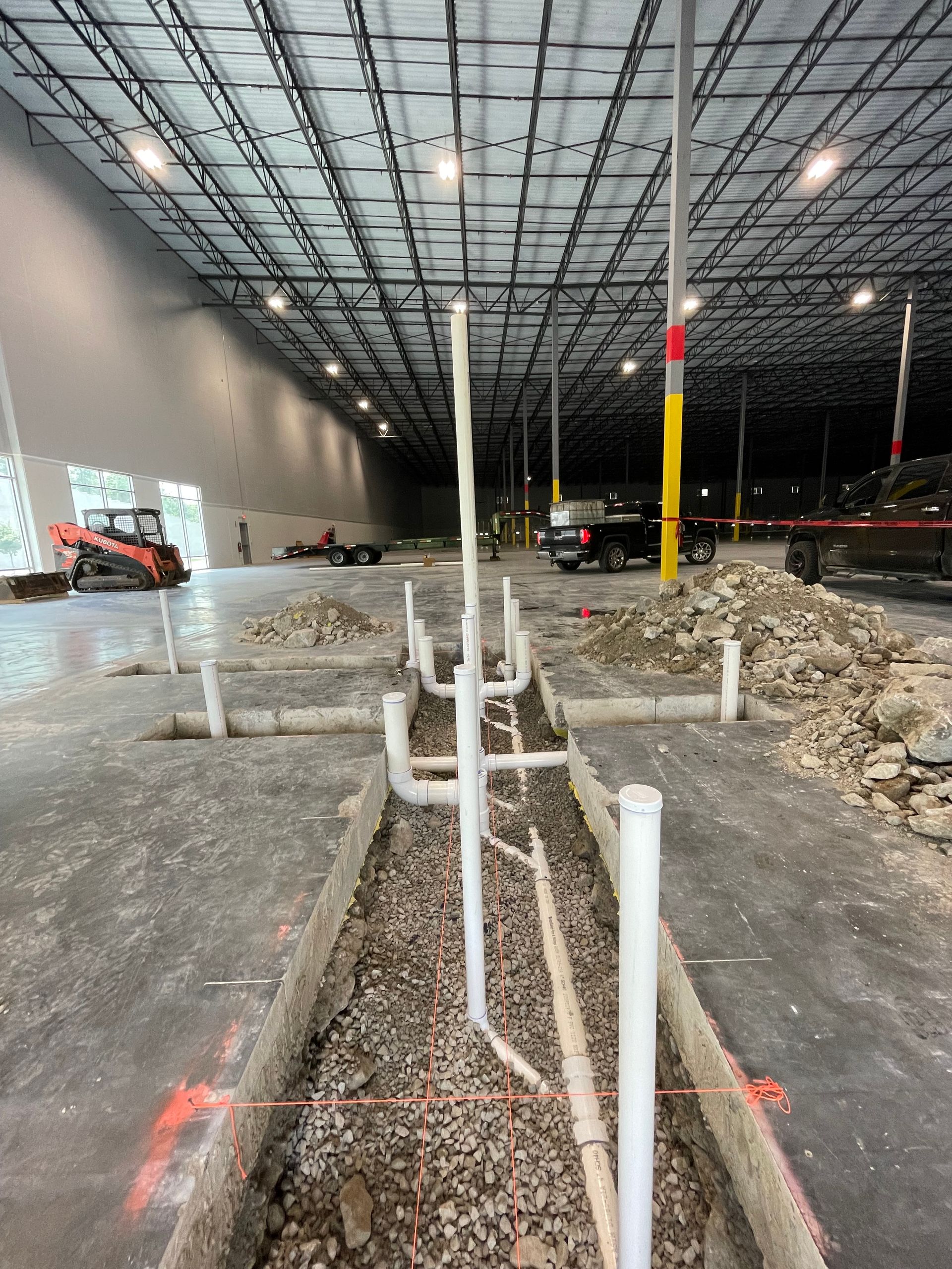 A large warehouse with a lot of pipes in it