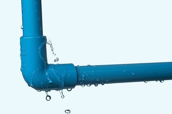 A blue pipe with water coming out of it on a white background.