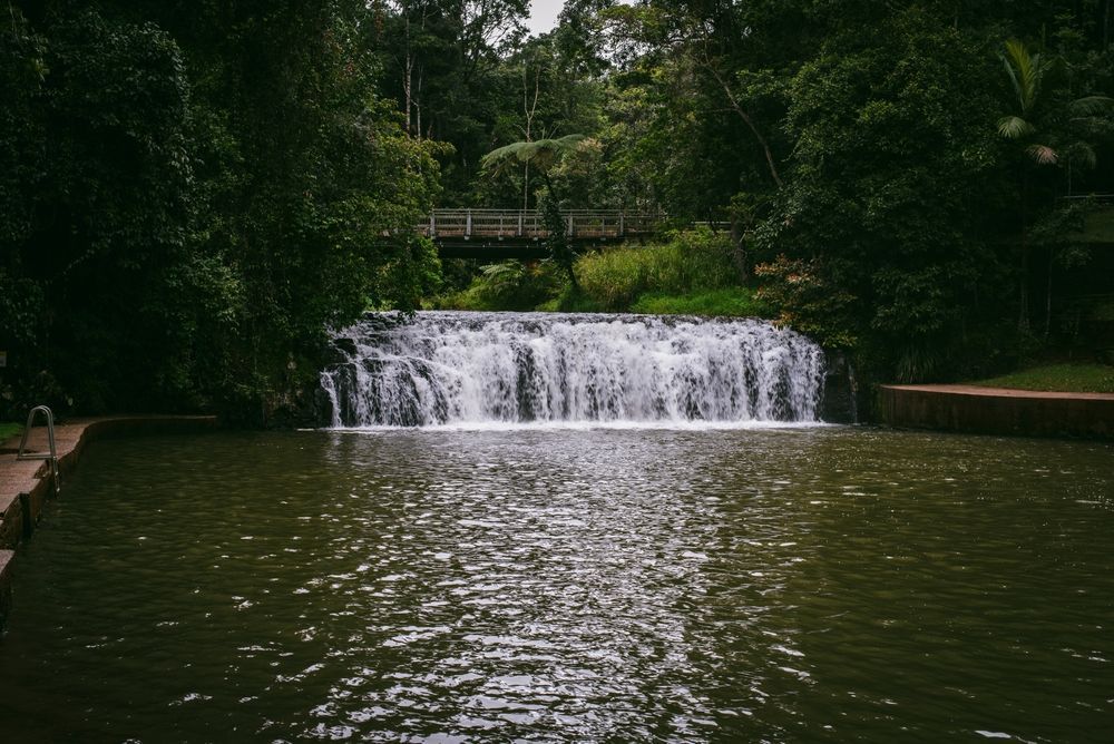 Waterfall Cascading Into a Dark Pond — O'Brien Carglass & Tinting in Malanda, QLD