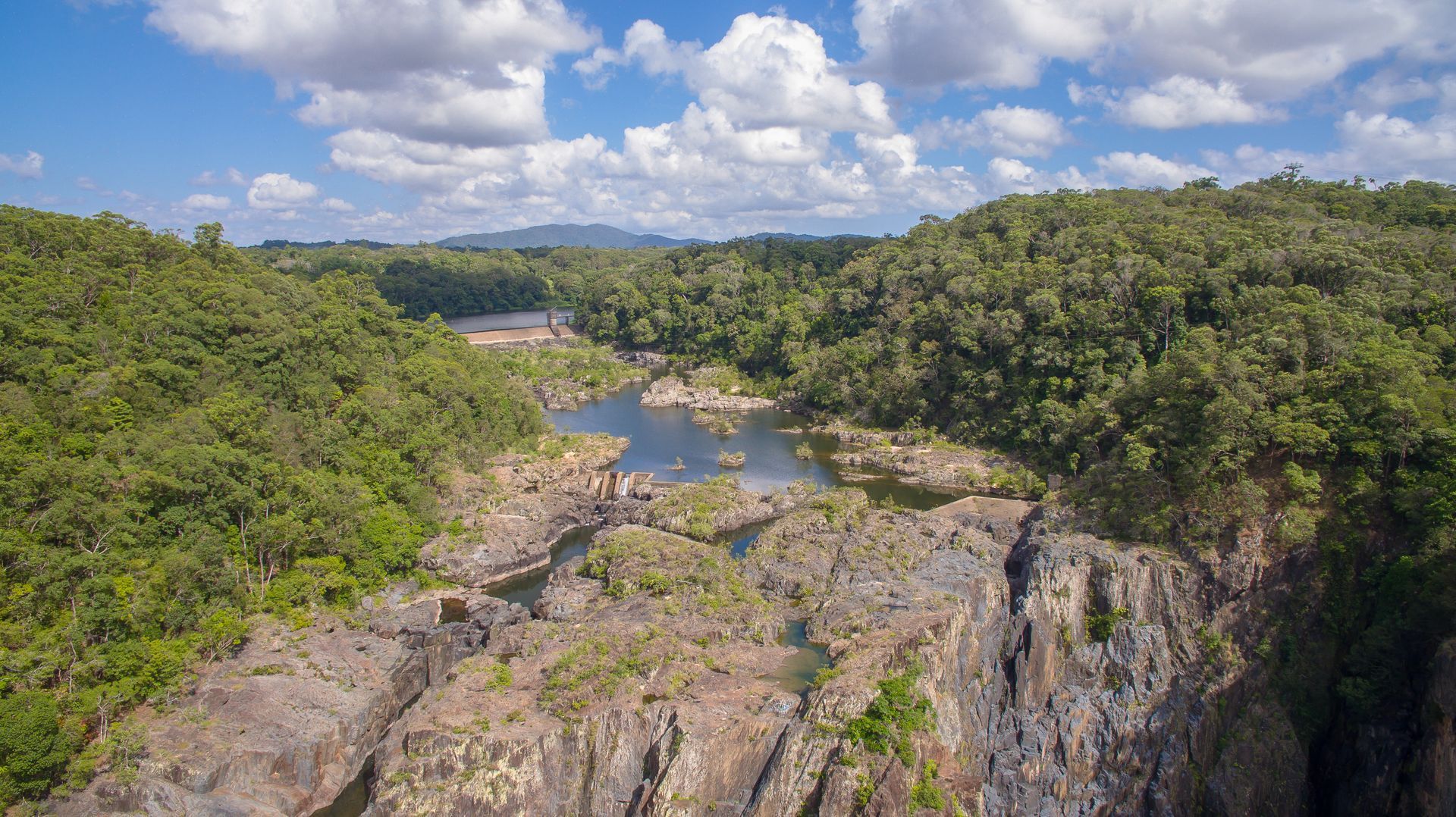 A Gorge With Water, Surrounded by Green Trees — O'Brien Carglass & Tinting in Kuranda, QLD