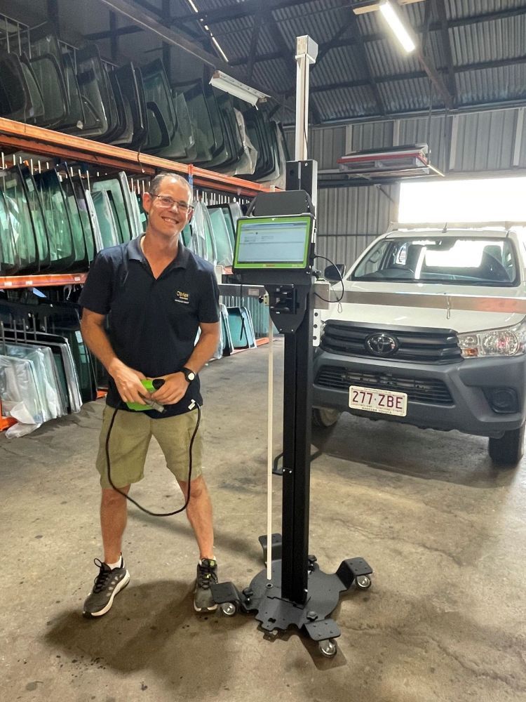 Friendly Technician holding Car Tint hanrdware — O'Brien Carglass & Tinting in Mareeba, QLD